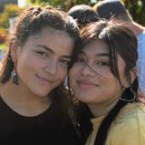 Two students smile while attending the Latinx Tailgate 2022.