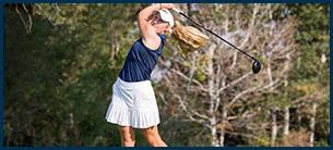 Woman golfer in a full back swing