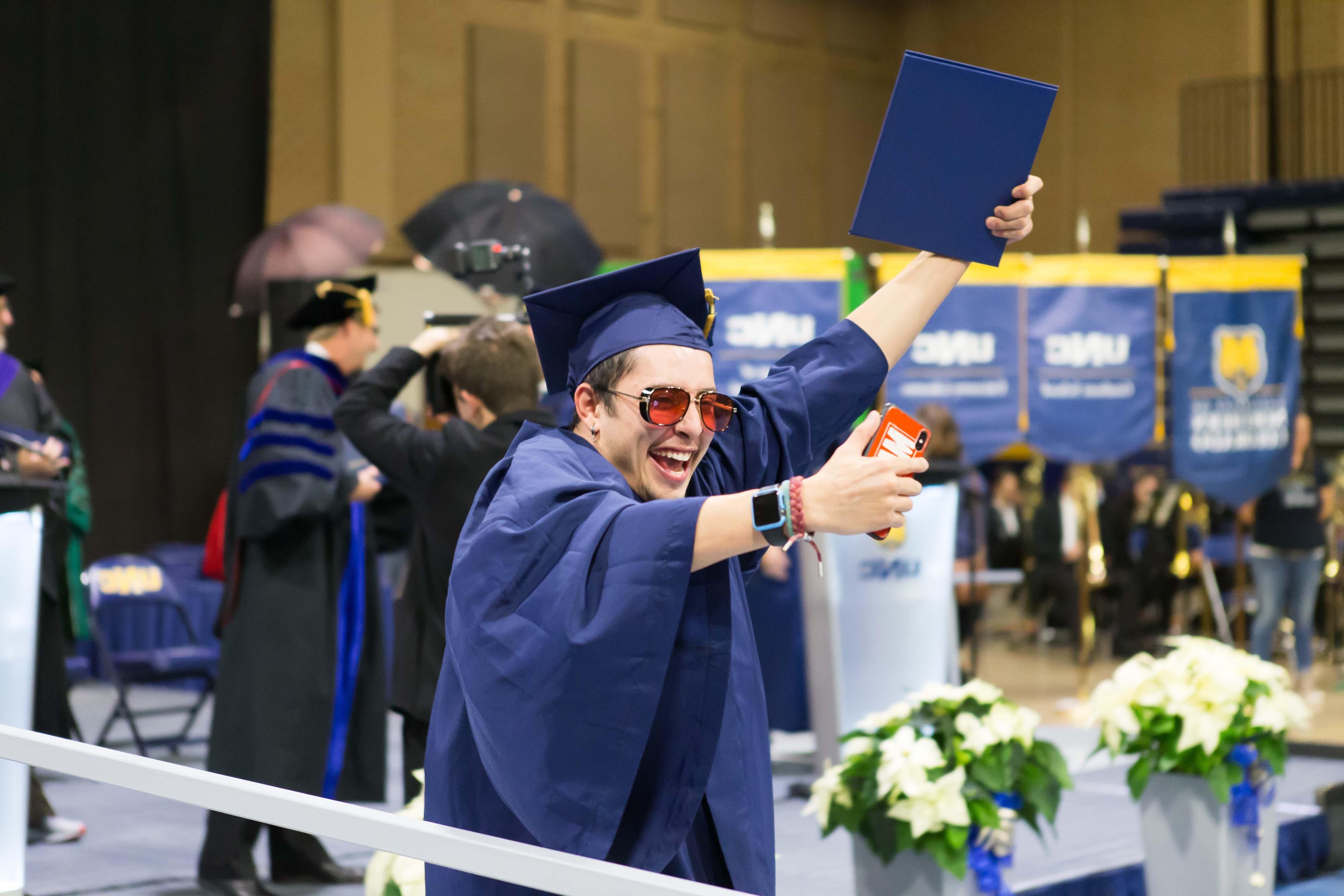 Student takes selfie with diploma
