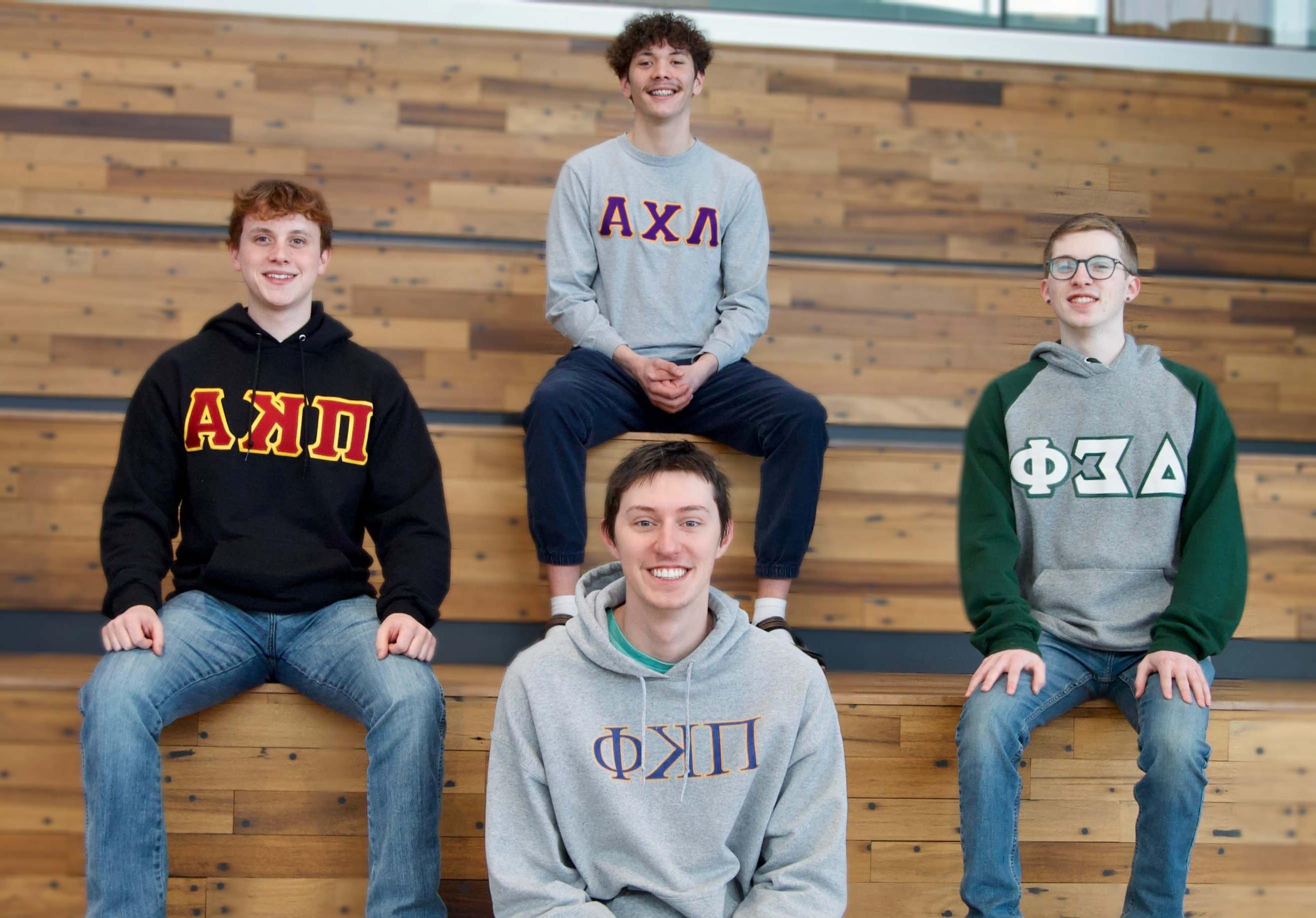 A group of NIC Fraternity members pose on a set of bleachers.