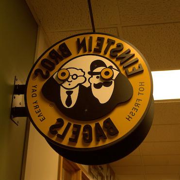 Einsteins Bagel Compnay sign hanging in the UC